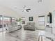 Bright living room with contemporary furniture, ceiling fan, and sliding glass doors for natural light at 3318 Dzuro Dr, Oxford, FL 34484