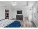 Main bedroom with tray ceilings, wood floors and a walk-in closet at 3318 Dzuro Dr, Oxford, FL 34484