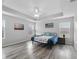 Spacious main bedroom featuring a tray ceiling, wood floors and ample natural light at 3318 Dzuro Dr, Oxford, FL 34484