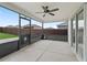 Screened patio with a ceiling fan, concrete floor, and view of the backyard at 3318 Dzuro Dr, Oxford, FL 34484