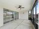 View of a covered patio area featuring a ceiling fan and sliding glass doors to the interior at 3318 Dzuro Dr, Oxford, FL 34484