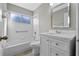 Clean bathroom with a tub/shower combination, tile surround, and a single vanity sink at 4324 Leafway Cir, Leesburg, FL 34748