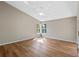 Bright bedroom with wood floors, neutral walls, and a modern ceiling fan with views through two windows at 4324 Leafway Cir, Leesburg, FL 34748