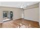 Bright bedroom featuring wood floors, neutral walls, and large sliding glass closet doors at 4324 Leafway Cir, Leesburg, FL 34748