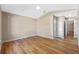 Bedroom with wood-look flooring, neutral walls, and an ensuite bathroom at 4324 Leafway Cir, Leesburg, FL 34748