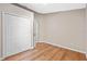 This bedroom has laminate wood flooring, a double door closet, and neutral paint at 4324 Leafway Cir, Leesburg, FL 34748