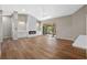 Bright living room with a fireplace, wood floors, and sliding doors to a screened patio at 4324 Leafway Cir, Leesburg, FL 34748