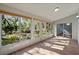 Enclosed sun room features tile flooring, sliding glass doors, clerestory lighting, and views of the backyard at 4324 Leafway Cir, Leesburg, FL 34748