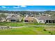 Aerial view of the property, showing a screened-in porch, a well-manicured lawn, and the surrounding community at 4835 Kelso St, Leesburg, FL 34748