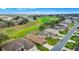 Aerial view of homes lining a street that overlooks a community golf course at 4835 Kelso St, Leesburg, FL 34748