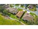 Aerial view of a well-maintained home on a manicured lawn adjacent to the golf course at 4835 Kelso St, Leesburg, FL 34748