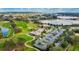 Scenic aerial view of a golf course, clubhouse, and community parking area at 4835 Kelso St, Leesburg, FL 34748