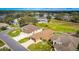 Aerial view of a single-story home in a community near a lake and golf course at 4835 Kelso St, Leesburg, FL 34748