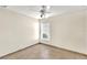 Bedroom with neutral walls and tile flooring, featuring a window with horizontal blinds at 4835 Kelso St, Leesburg, FL 34748