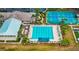 Aerial view of a large, resort-style pool surrounded by lounge chairs and palm trees at 4835 Kelso St, Leesburg, FL 34748