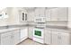 Bright kitchen featuring white cabinets, modern appliances, and stylish countertops at 4835 Kelso St, Leesburg, FL 34748