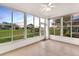 Bright sunroom surrounded by large windows, offering views of the outdoors at 4835 Kelso St, Leesburg, FL 34748