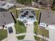 Aerial view of a two-story home featuring solar panels, a screened-in pool, and a well-kept lawn at 5363 Timberland Ave, St Cloud, FL 34771