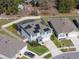 An aerial view shows a property with a screened-in pool, solar panels, landscaped yard, and fenced perimeter at 5363 Timberland Ave, St Cloud, FL 34771