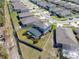 Aerial view of a home with a screened-in pool, a well-maintained lawn, and a white fence at 5363 Timberland Ave, St Cloud, FL 34771