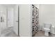 Bathroom with walk-in shower, patterned curtain and neutral tiling at 5363 Timberland Ave, St Cloud, FL 34771