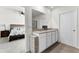 Bright bathroom featuring a double sink vanity with granite countertops and a bedroom in the background at 5363 Timberland Ave, St Cloud, FL 34771