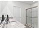 Well-lit bathroom with granite countertops, a clear mirror, and a modern glass shower stall at 5363 Timberland Ave, St Cloud, FL 34771