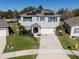 Two-story home with solar panels, a well-kept lawn, and a two-car garage at 5363 Timberland Ave, St Cloud, FL 34771