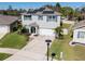 Attractive two-story home with a manicured lawn, solar panels, and a two-car garage at 5363 Timberland Ave, St Cloud, FL 34771