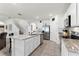 Bright kitchen featuring granite countertops, stainless steel appliances, tile backsplash, and an island sink at 5363 Timberland Ave, St Cloud, FL 34771