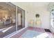 Tiled Florida room with chairs, a ceiling fan, and sliding glass doors leading to the main house at 592 Juniper Way, Tavares, FL 32778