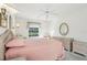 Airy main bedroom featuring neutral decor, a ceiling fan, and wicker furnishings for a serene retreat at 592 Juniper Way, Tavares, FL 32778