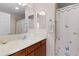 Bathroom featuring a vanity with wood cabinets, large mirror, and shower with patterned curtain at 620 Vagabond St, The Villages, FL 32163