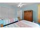 Spacious bedroom featuring two twin beds, closet, dresser, and a ceiling fan at 620 Vagabond St, The Villages, FL 32163