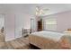 Comfortable bedroom featuring wood-look floors, ceiling fan, and a decorative quilt at 620 Vagabond St, The Villages, FL 32163