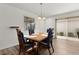 Traditional dining room featuring hardwood floors, chandelier, and a sliding glass door to the outdoor area at 620 Vagabond St, The Villages, FL 32163