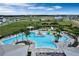 Aerial view of the community pool with seating and a splash pad at 7193 Dilly Lake Ave, Groveland, FL 34736