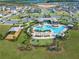 Aerial view of neighborhood pool featuring a playground and recreation center at 7193 Dilly Lake Ave, Groveland, FL 34736