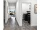 Hallway with hard floors and a view of the laundry room at 7193 Dilly Lake Ave, Groveland, FL 34736