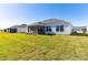 New home features expansive lawn and screened lanai at 7315 Cornwall Way, The Villages, FL 34762