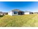 New home features expansive lawn and screened lanai at 7315 Cornwall Way, The Villages, FL 34762