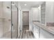 Ensuite bathroom features walk-in shower and dual sink vanity at 7315 Cornwall Way, The Villages, FL 34762