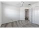 This bedroom features a ceiling fan and a doorway leading to another room at 7315 Cornwall Way, The Villages, FL 34762