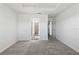 Bright bedroom featuring neutral carpet, ensuite bathroom, and walk-in closet at 7315 Cornwall Way, The Villages, FL 34762
