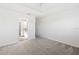 Bright bedroom featuring neutral carpet, ensuite bathroom, and walk-in closet at 7315 Cornwall Way, The Villages, FL 34762
