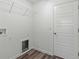 Laundry closet with storage shelves and hanging rack at 7315 Cornwall Way, The Villages, FL 34762