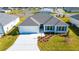 New home featuring manicured lawn and front garden at 7315 Cornwall Way, The Villages, FL 34762