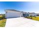 Attractive home featuring a spacious driveway and well-maintained landscaping at 7315 Cornwall Way, The Villages, FL 34762