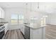 Kitchen island featuring a stainless steel dishwasher and stainless steel faucet at 7315 Cornwall Way, The Villages, FL 34762