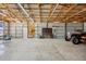 Large barn with exposed wooden beams, concrete floor, tractor, and ample workspace at 8230 Se 23Rd Dr, Webster, FL 33597